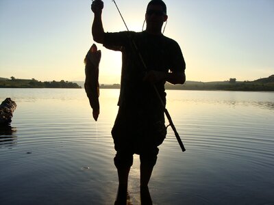 Fisherman silhouette fish