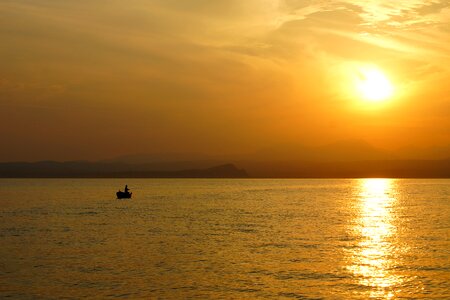 Fisherman fishing boat sunset photo