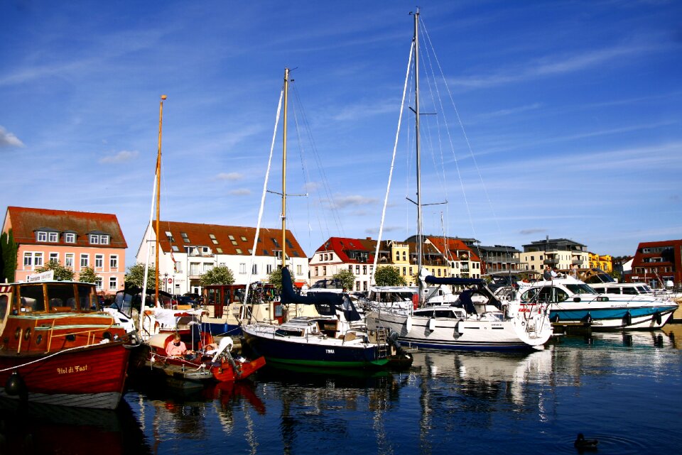 Reflections in the water blue yachts on the shore