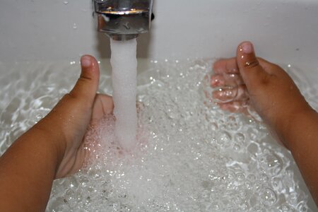 Child hands hands water play