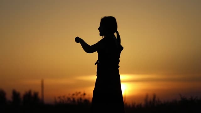Sunset silhouette young woman