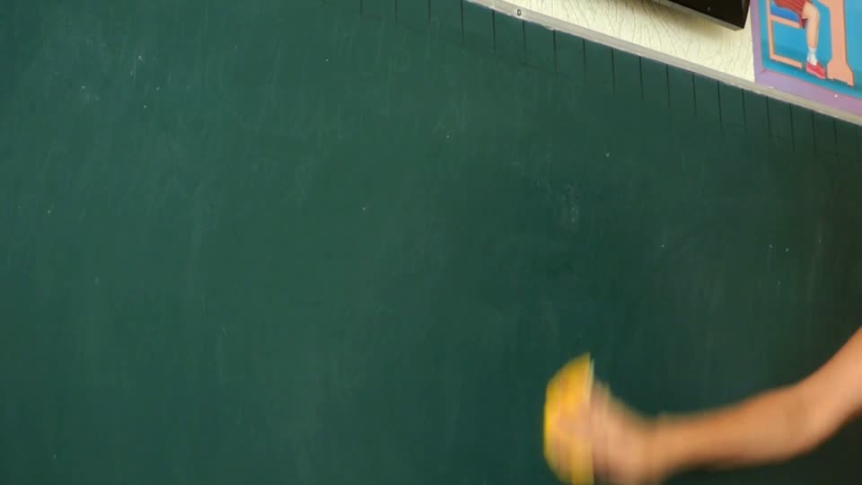 The teacher writes homework the teacher wipes the board yellow cloth