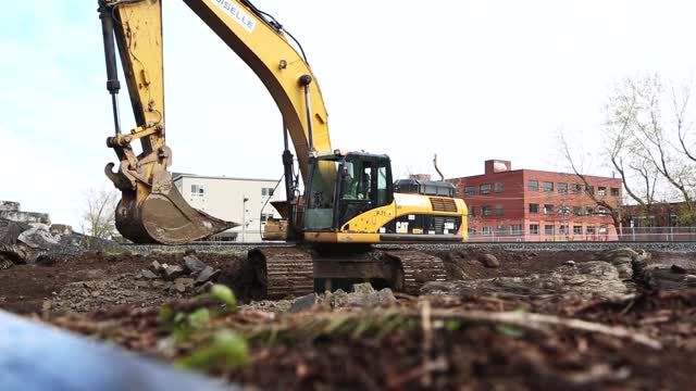 Construction site excavator digging