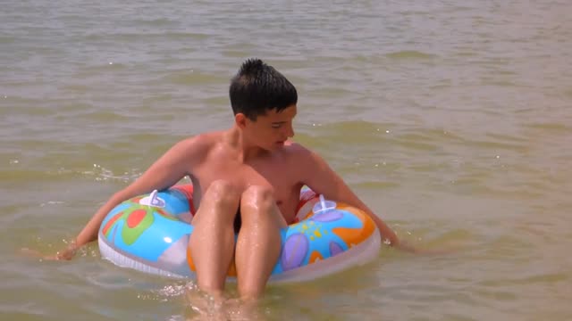 Young man to swim rubber ring