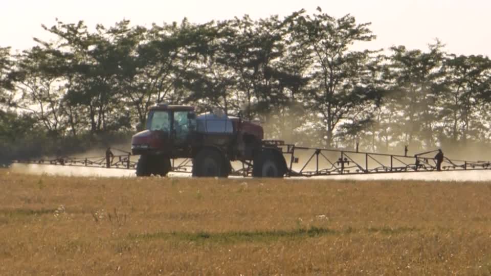 Tractor in field spraying fertilizer tractor bulldozer