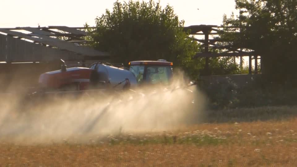 Tractor in field spraying fertilizer tractor bulldozer