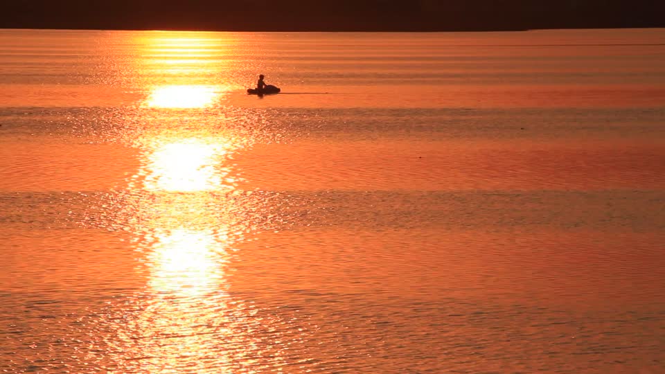 Evening lake fisherman