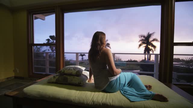 Young woman big window island