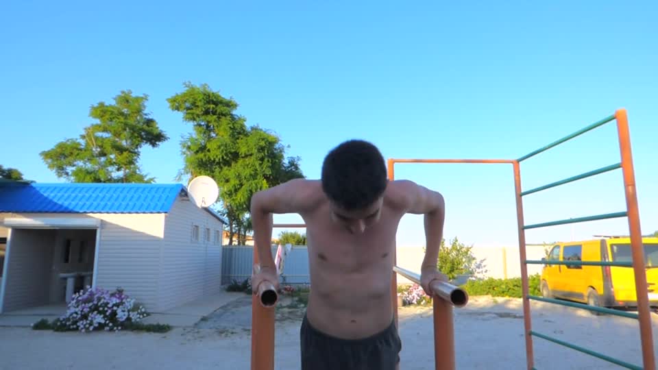 The guy pressed on the bars young man boy