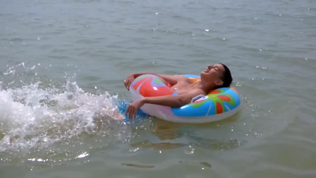 Young man to swim rubber ring