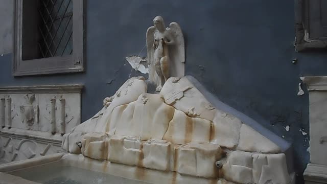 The Parthenope Siren with viola on Vesuvius and Spain coat-of-arms" - The "Spinacorona" fountain (16th century) in Naples