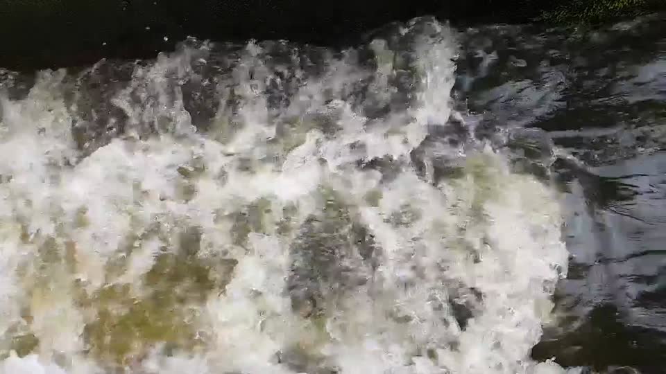 slow motion water flowing down a sluice - 720p