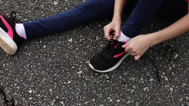 Girl Tying Sneaker