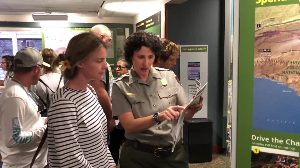 Ranger Benita assisting visitors at Kīlauea Visitor Center on opening day