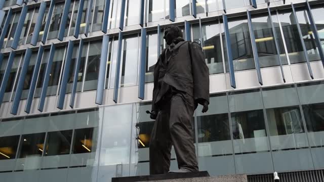 London. South Bank. "Non plaudite modo pecuniam jacite" translates as "Do not applaud, just throw money".  Watch the movie of the statue.