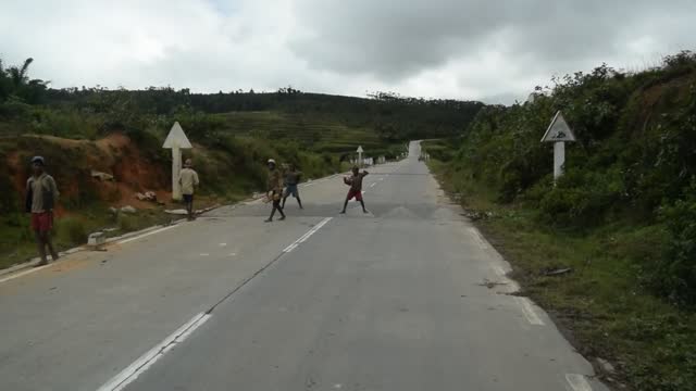 Madagascar. Morondava to Antsirabe. We often seen lone boys and girls, "repairing the potholes" in the road, wanting a small hand out.