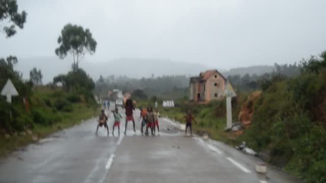 Madagascar. Morondava to Antsirabe.  We often seen lone boys and girls, "repairing the potholes" in the road, wanting a small hand out.